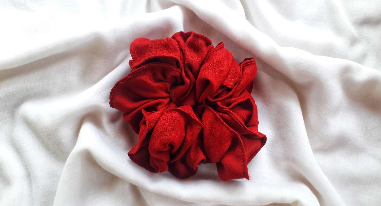 red scrunchie on a messy white background